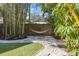 Relaxing backyard setting with a hammock, artificial grass, landscaping, and bamboo trees at 468 11Th N Ave, St Petersburg, FL 33701