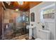 Bathroom featuring a stone shower, stylish vanity with pedestal sink, and natural light from the window at 468 11Th N Ave, St Petersburg, FL 33701