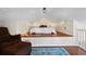 Charming bedroom featuring wood platform bed, plush chair, and decorative blue rug at 468 11Th N Ave, St Petersburg, FL 33701