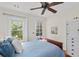 Bright bedroom with backyard views, hardwood floors, and a ceiling fan at 468 11Th N Ave, St Petersburg, FL 33701