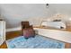 Cozy bedroom with a wood platform bed, a plush chair, and a decorative blue rug at 468 11Th N Ave, St Petersburg, FL 33701