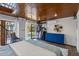 Bright bedroom featuring hardwood ceiling, dresser, closet, and backyard access through French doors at 468 11Th N Ave, St Petersburg, FL 33701