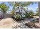 Charming white bungalow with mature landscaping, inviting curb appeal, and concrete driveway at 468 11Th N Ave, St Petersburg, FL 33701