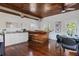 Modern kitchen area with a custom wood bar, hardwood floors, white cabinets, and ample counter space at 468 11Th N Ave, St Petersburg, FL 33701