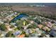 Aerial view of a residential community featuring a pond and lush greenery at 5292 Kernwood Ct, Palm Harbor, FL 34685