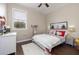 Bright bedroom with a white bed, white dresser, and a ceiling fan at 5292 Kernwood Ct, Palm Harbor, FL 34685