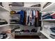 Organized walk-in closet featuring shelving and hanging rods for optimal storage at 5292 Kernwood Ct, Palm Harbor, FL 34685