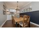 Elegant dining room with hardwood floors, a wooden table, and stylish wall decor, creating an ideal setting for meals at 5292 Kernwood Ct, Palm Harbor, FL 34685