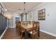 Bright dining room with a chandelier, wood table and floors, and arched doorway at 5292 Kernwood Ct, Palm Harbor, FL 34685