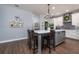 Spacious kitchen island with seating, pendant lighting, and white cabinetry, perfect for casual dining and entertaining at 5292 Kernwood Ct, Palm Harbor, FL 34685