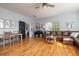 Open-concept living room with hardwood floors, a sofa, piano, and a dining table at 5292 Kernwood Ct, Palm Harbor, FL 34685