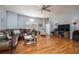 Bright living room with hardwood floors, a comfortable sofa, and a ceiling fan at 5292 Kernwood Ct, Palm Harbor, FL 34685