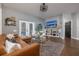 Comfortable living room features hardwood floors, a leather sofa, and built-in shelving, creating a cozy and inviting space at 5292 Kernwood Ct, Palm Harbor, FL 34685