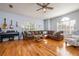 Spacious living room with hardwood floors, a comfortable sofa, and a ceiling fan at 5292 Kernwood Ct, Palm Harbor, FL 34685