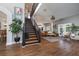 Open-concept living room featuring a staircase, hardwood floors, and neutral color palette at 5292 Kernwood Ct, Palm Harbor, FL 34685