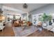 Bright living room featuring hardwood floors, a leather sofa, and a seamless transition into the modern kitchen area at 5292 Kernwood Ct, Palm Harbor, FL 34685