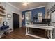 Bright office with wood floors, blue accent wall, modern white desk, and shelving at 5292 Kernwood Ct, Palm Harbor, FL 34685