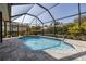 Relaxing screened-in pool area with lush tropical landscaping at 5292 Kernwood Ct, Palm Harbor, FL 34685