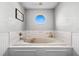 Relaxing bathroom with soaking tub and octagon window at 5714 S 1St St, Tampa, FL 33611