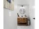 Modern bathroom with hexagon tile floor, wooden vanity, and white subway tile shower at 5714 S 1St St, Tampa, FL 33611