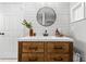 Stylish bathroom with white shiplap, a large round mirror, and a modern wooden vanity at 5714 S 1St St, Tampa, FL 33611