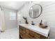 Updated bathroom features hexagon floor tile, white shiplap walls, and a wooden vanity at 5714 S 1St St, Tampa, FL 33611