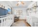 Bedroom featuring a crib, armchair, and built-in shelves at 5714 S 1St St, Tampa, FL 33611