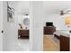 View of bedroom and bathroom with light wood floors and a modern aesthetic at 5714 S 1St St, Tampa, FL 33611