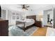 Main bedroom with wood floors, a king bed, and access to a home gym at 5714 S 1St St, Tampa, FL 33611