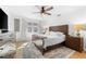 Bright bedroom with king bed, wood floors and ceiling fan at 5714 S 1St St, Tampa, FL 33611