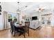 Open dining area with a wooden table and chairs, adjacent to the living room at 5714 S 1St St, Tampa, FL 33611