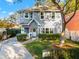 Two-story gray house with a white door, landscaping, and a driveway at 5714 S 1St St, Tampa, FL 33611