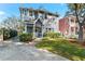 Two-story gray house with a white door, landscaping, and a driveway at 5714 S 1St St, Tampa, FL 33611