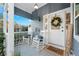 Inviting front porch with rocking chairs and a welcome sign at 5714 S 1St St, Tampa, FL 33611