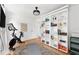 Home gym with Peloton bike and built-in bookshelves at 5714 S 1St St, Tampa, FL 33611