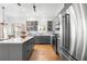 Modern kitchen with stainless steel appliances and gray cabinets at 5714 S 1St St, Tampa, FL 33611