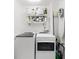 Bright laundry room with washer, dryer, and additional storage shelves at 5714 S 1St St, Tampa, FL 33611