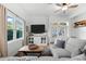 Comfortable living room featuring a sectional sofa and a large TV at 5714 S 1St St, Tampa, FL 33611