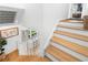 Bright, modern staircase with light wood treads and white risers at 5714 S 1St St, Tampa, FL 33611