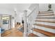 White staircase with wooden steps leading to the living room at 5714 S 1St St, Tampa, FL 33611