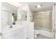 Clean bathroom with bright lighting, a bathtub with shower and a large mirror at 5940 Pelican Bay S Plz # Ph E, Gulfport, FL 33707