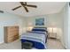 A cozy bedroom features soft lighting, a ceiling fan, and calming decor for a peaceful night's sleep at 5940 Pelican Bay S Plz # Ph E, Gulfport, FL 33707