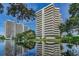 Beautiful shot of the high-rise condo complex with a serene lake and fountain in the foreground at 5940 Pelican Bay S Plz # Ph E, Gulfport, FL 33707