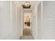 Inviting hallway featuring ample storage with closet doors leading to a bright, furnished room at 5940 Pelican Bay S Plz # Ph E, Gulfport, FL 33707