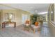 Warm lobby featuring sitting area with mirror and tropical plants at 5940 Pelican Bay S Plz # Ph E, Gulfport, FL 33707