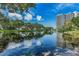 Scenic view of the pond, reflecting building and blue skies at 5940 Pelican Bay S Plz # Ph E, Gulfport, FL 33707