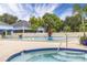 Beautiful community pool and hot tub surrounded by lush landscaping and lounge chairs at 5940 Pelican Bay S Plz # Ph E, Gulfport, FL 33707