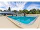 Large outdoor swimming pool with a '6 FT' depth marker and umbrellas at an outdoor club at 5940 Pelican Bay S Plz # Ph E, Gulfport, FL 33707