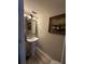 Stylish half bath with pedestal sink, framed mirror and artwork at 6113 Freeport Dr, Spring Hill, FL 34606