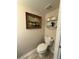 Cozy half bath featuring a comfort height toilet and charming decor at 6113 Freeport Dr, Spring Hill, FL 34606